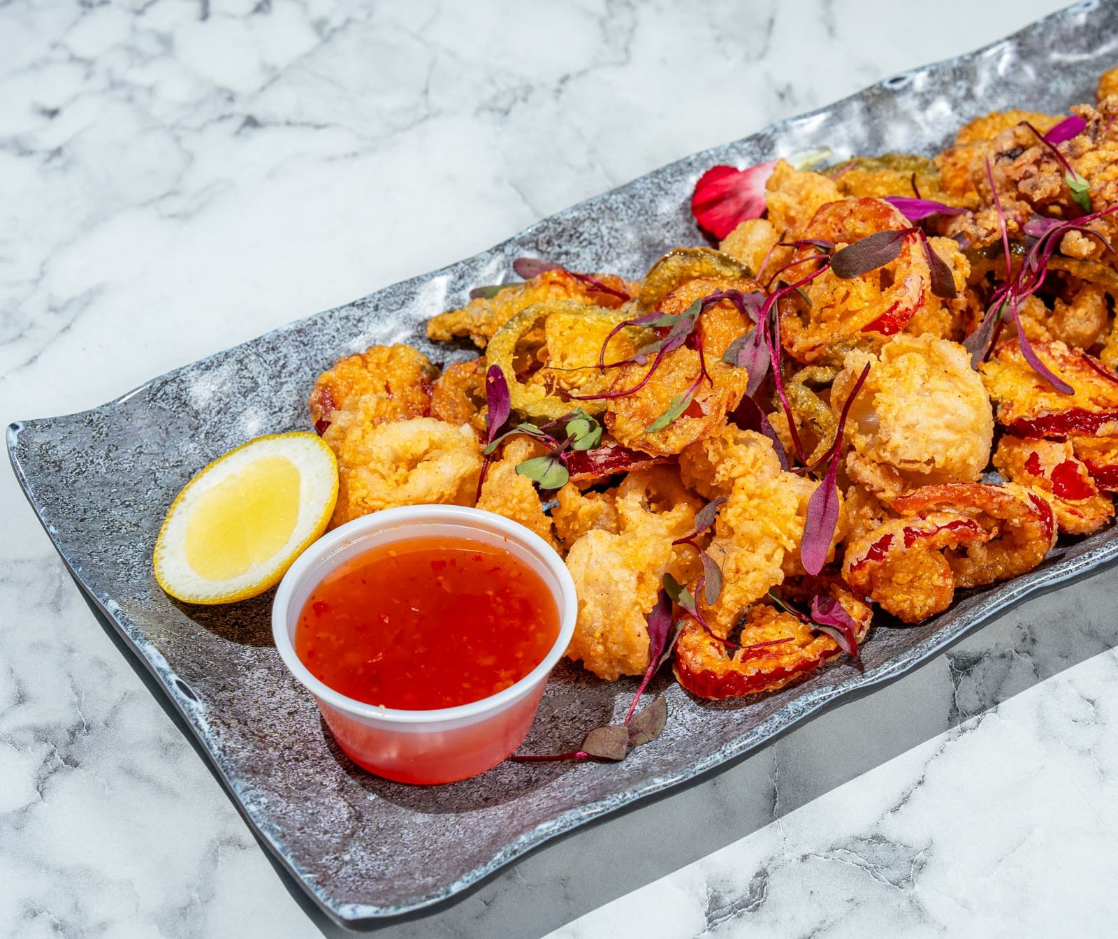 Fried calamari with cherry peppers, lemon and chili sauce